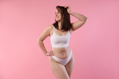 Photo of Woman in underwear on pink background. Cellulite problem