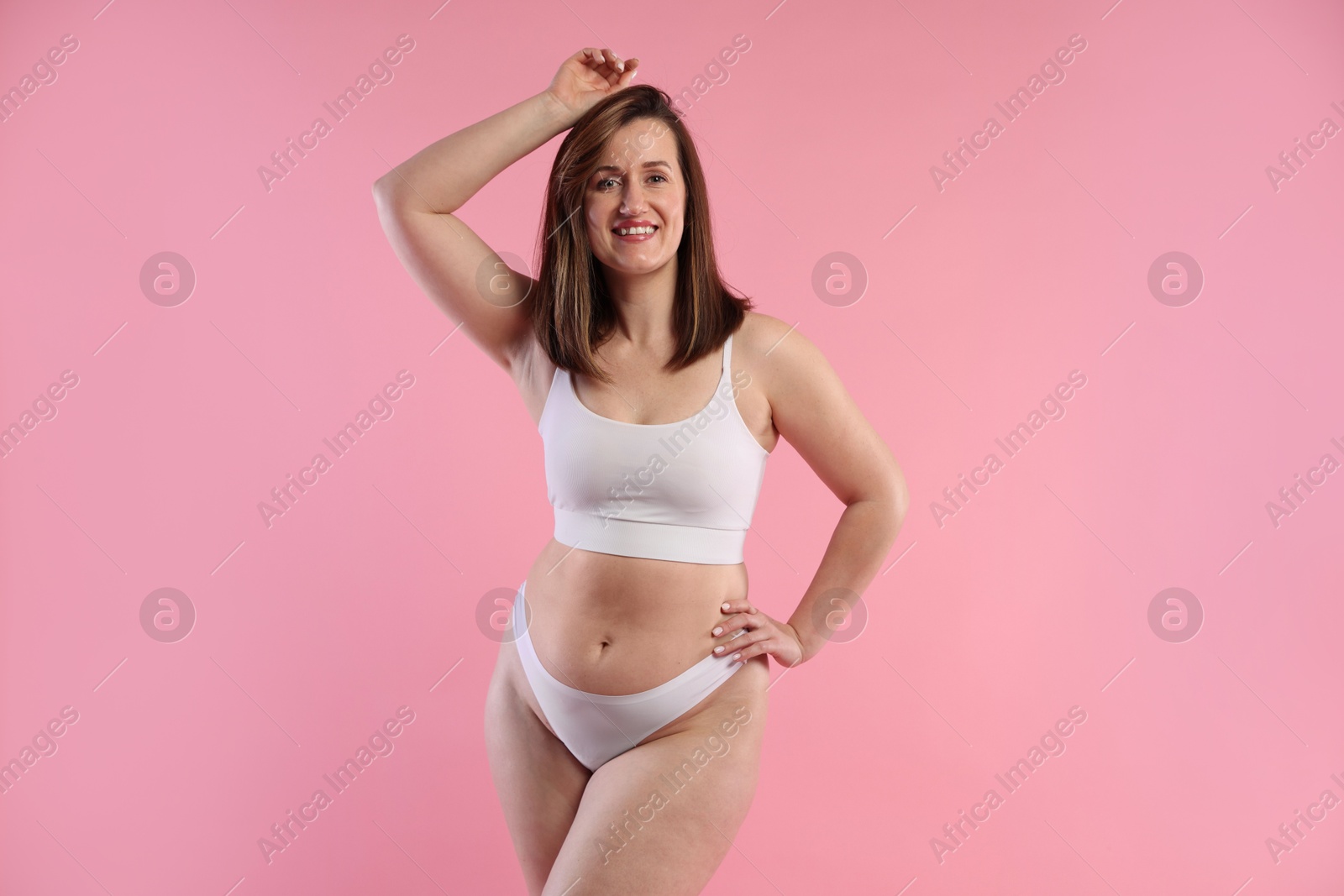 Photo of Woman in underwear on pink background. Cellulite problem