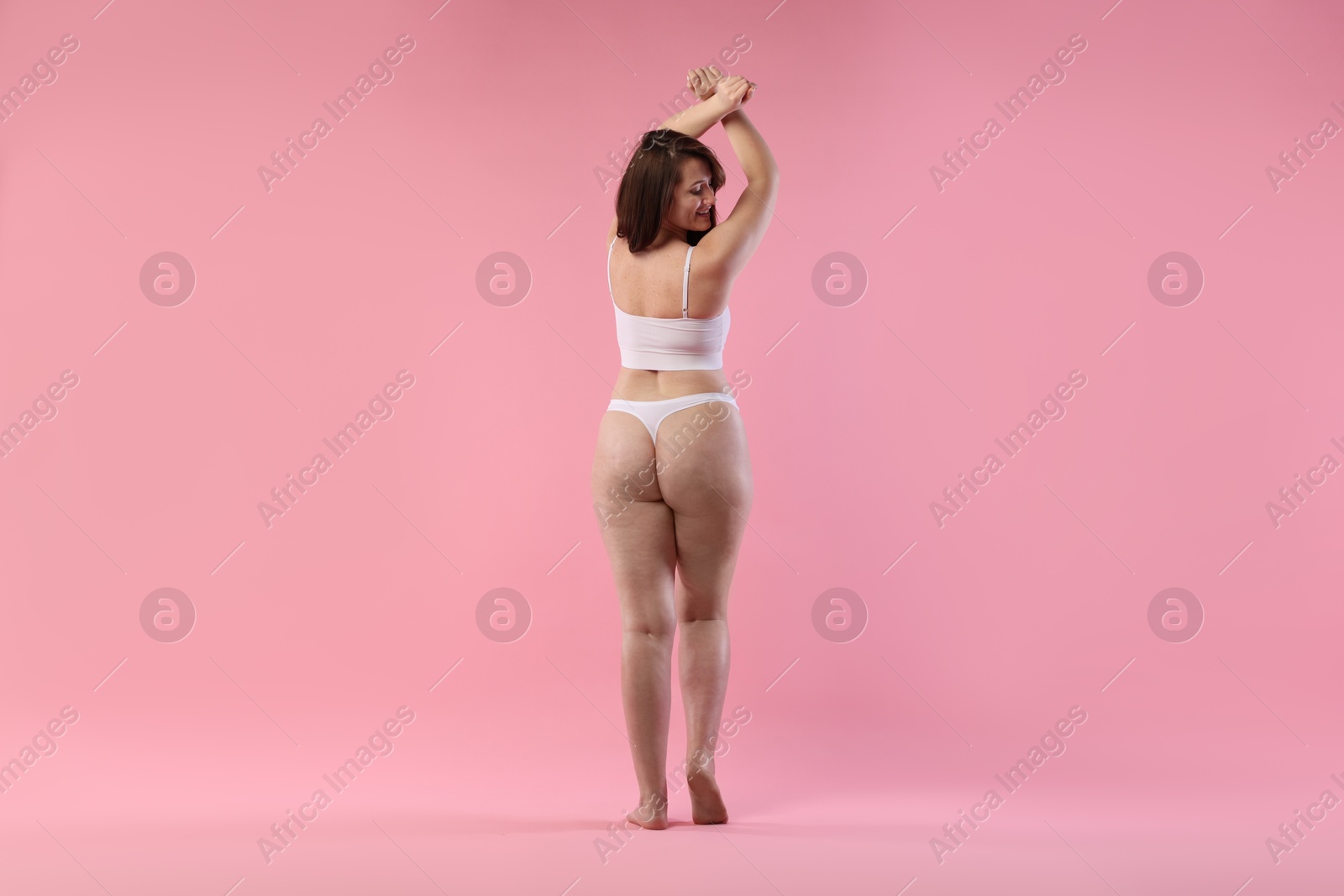 Photo of Woman in underwear on pink background. Cellulite problem