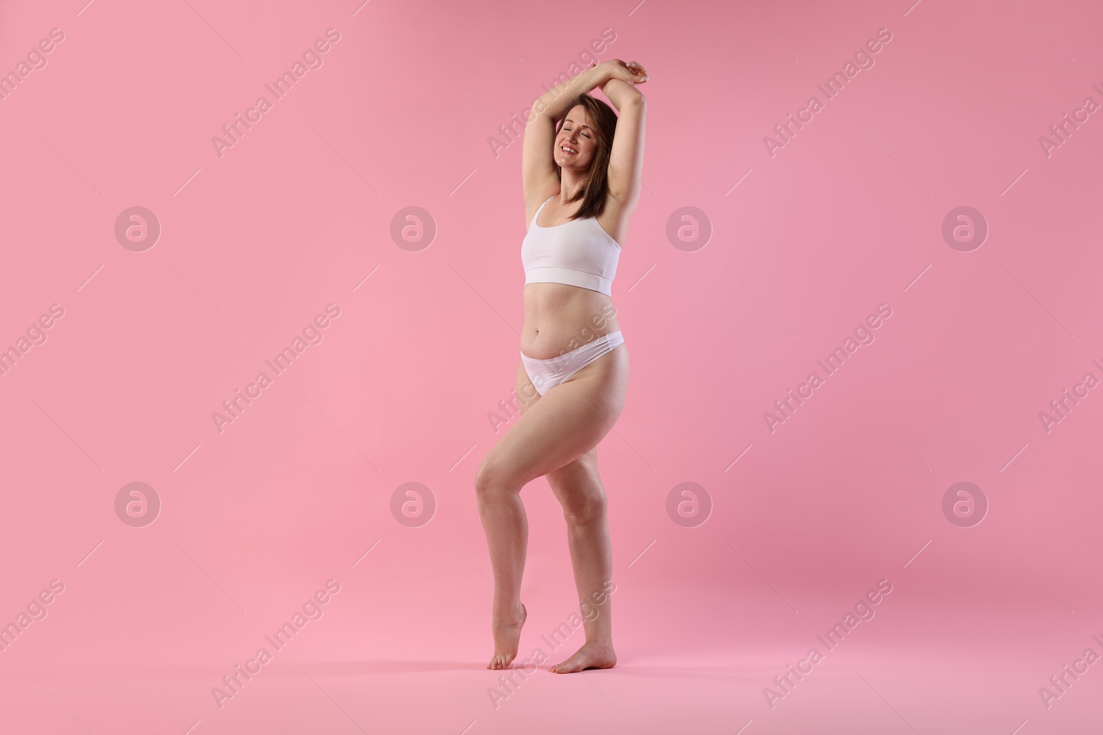 Photo of Woman in underwear on pink background, space for text. Cellulite problem