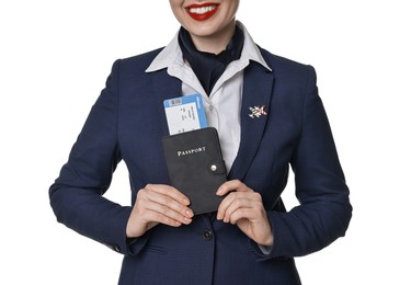 Happy stewardess holding passport with flight ticket on white background, closeup