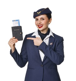 Photo of Happy stewardess pointing at passport with flight ticket on white background