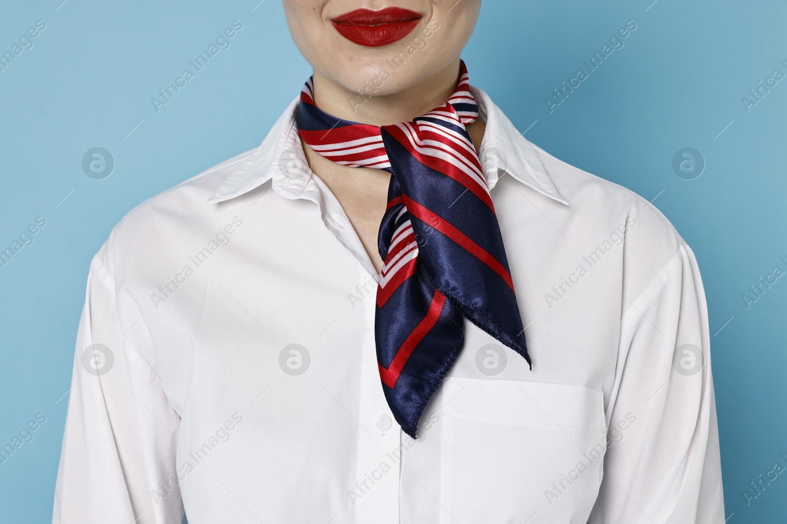 Photo of Flight attendant on light blue background, closeup