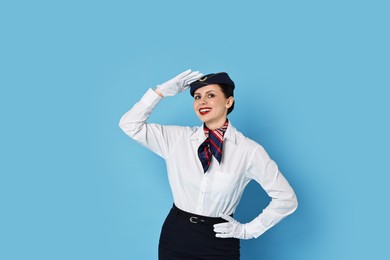 Photo of Happy flight attendant on light blue background