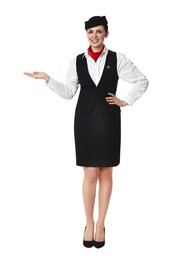 Photo of Smiling flight attendant showing something on white background