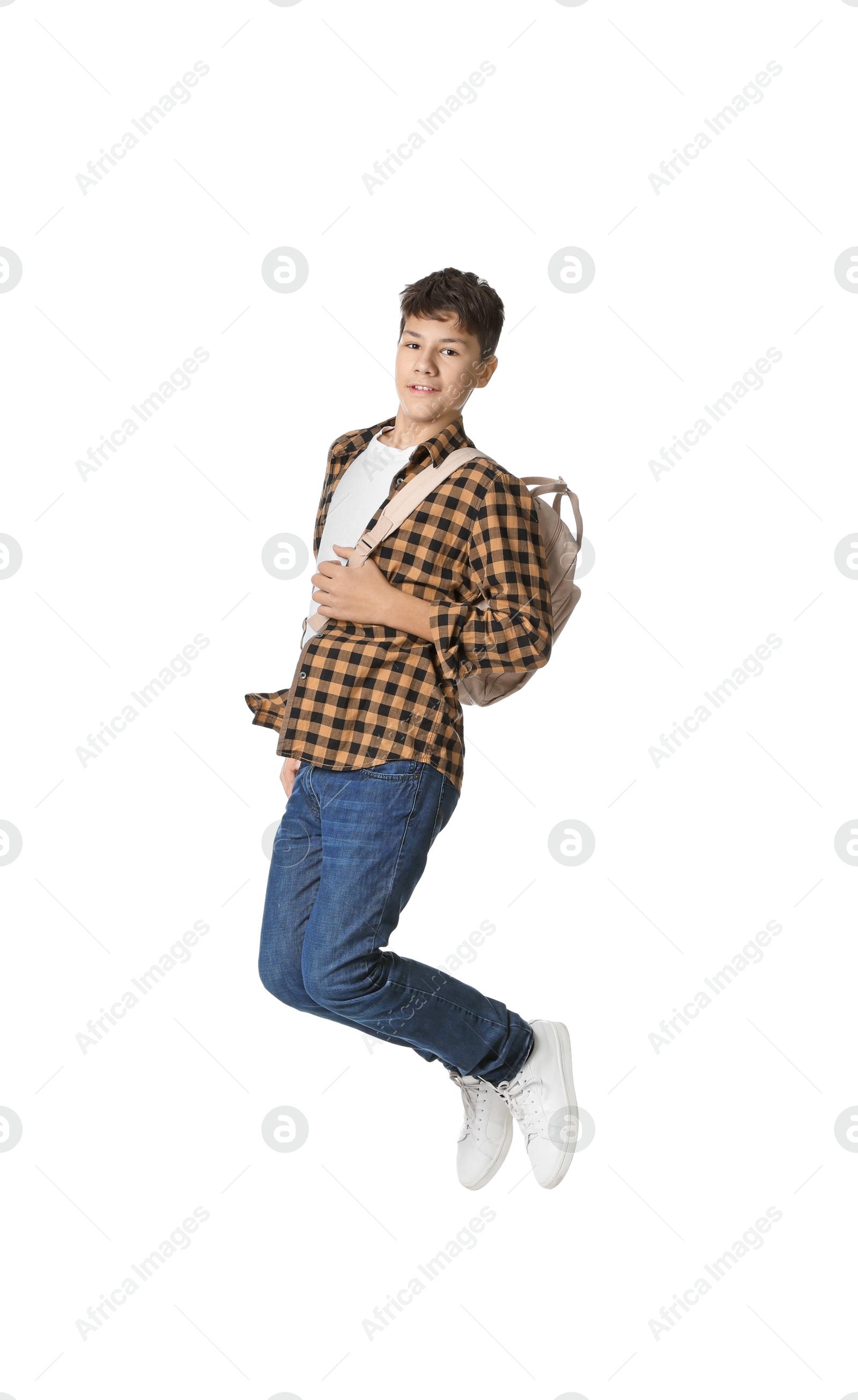 Photo of Teenage boy with backpack jumping on white background