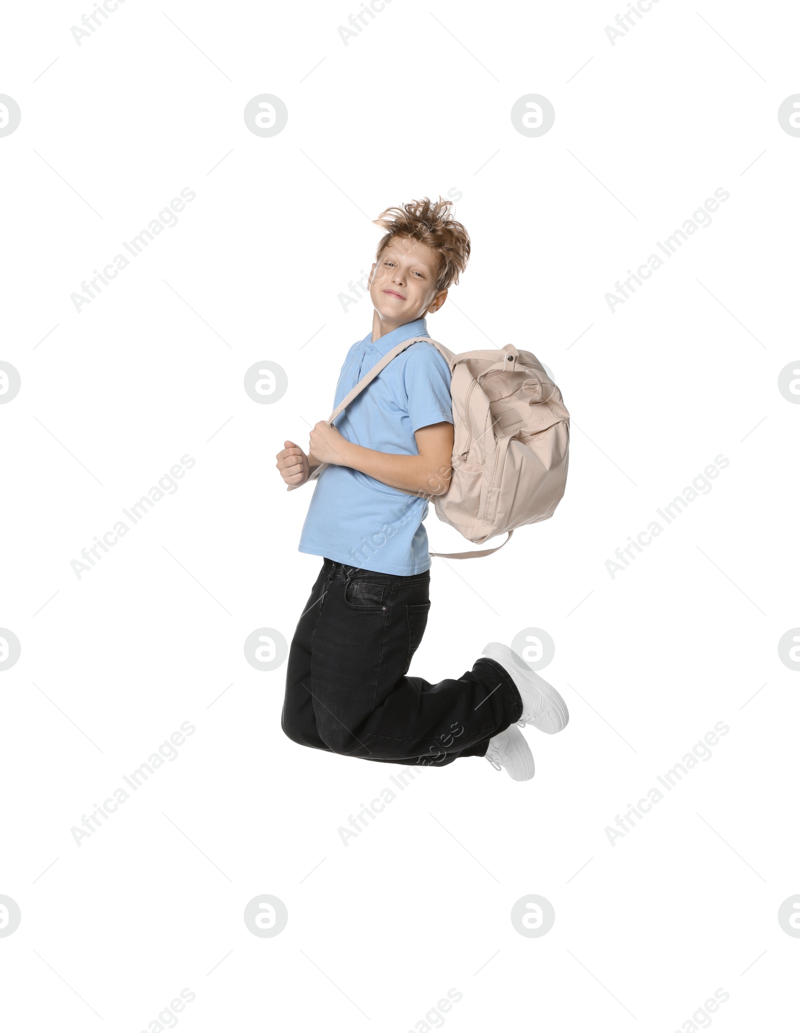 Photo of Teenage boy with backpack jumping on white background