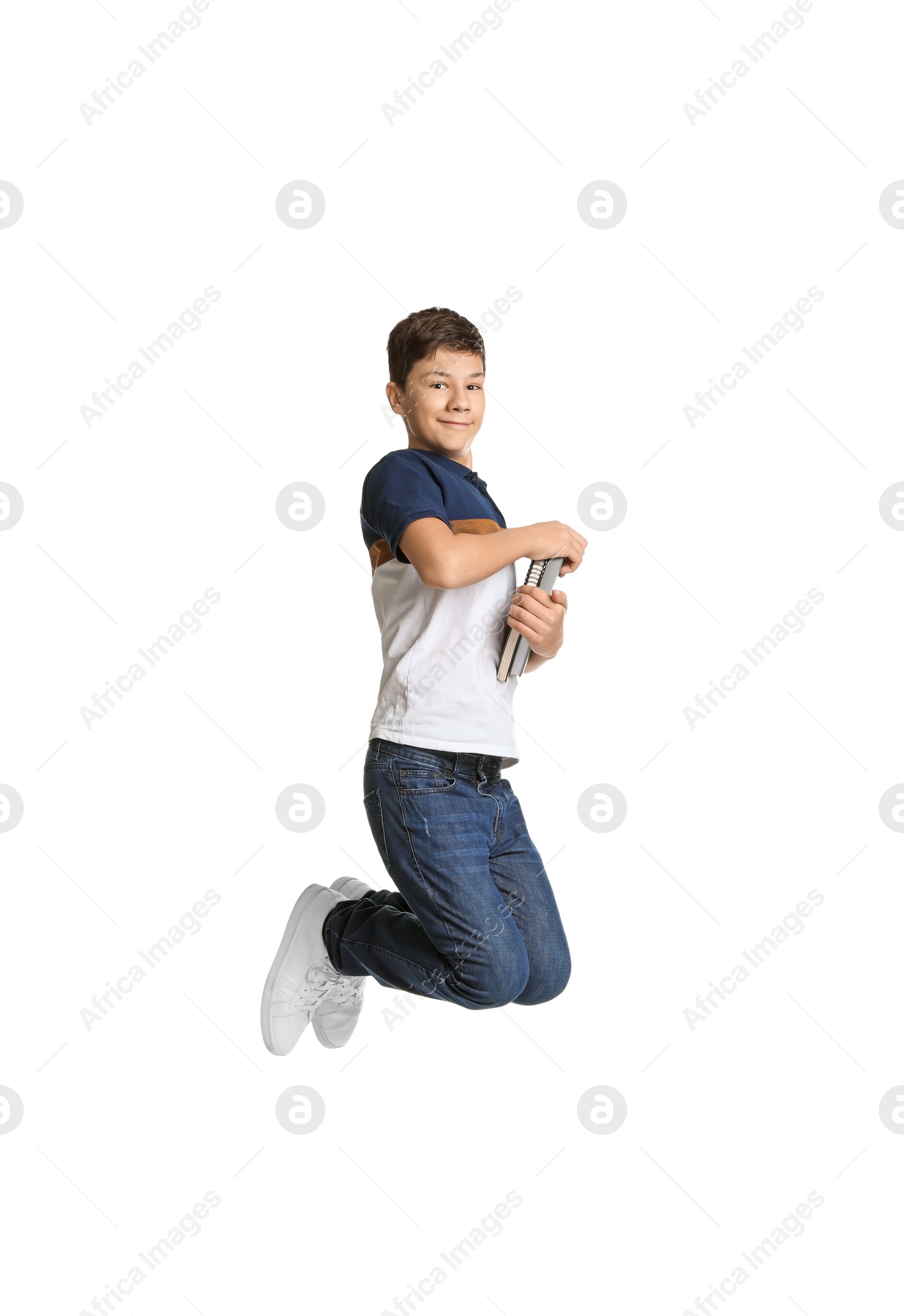 Photo of Teenage boy with books jumping on white background