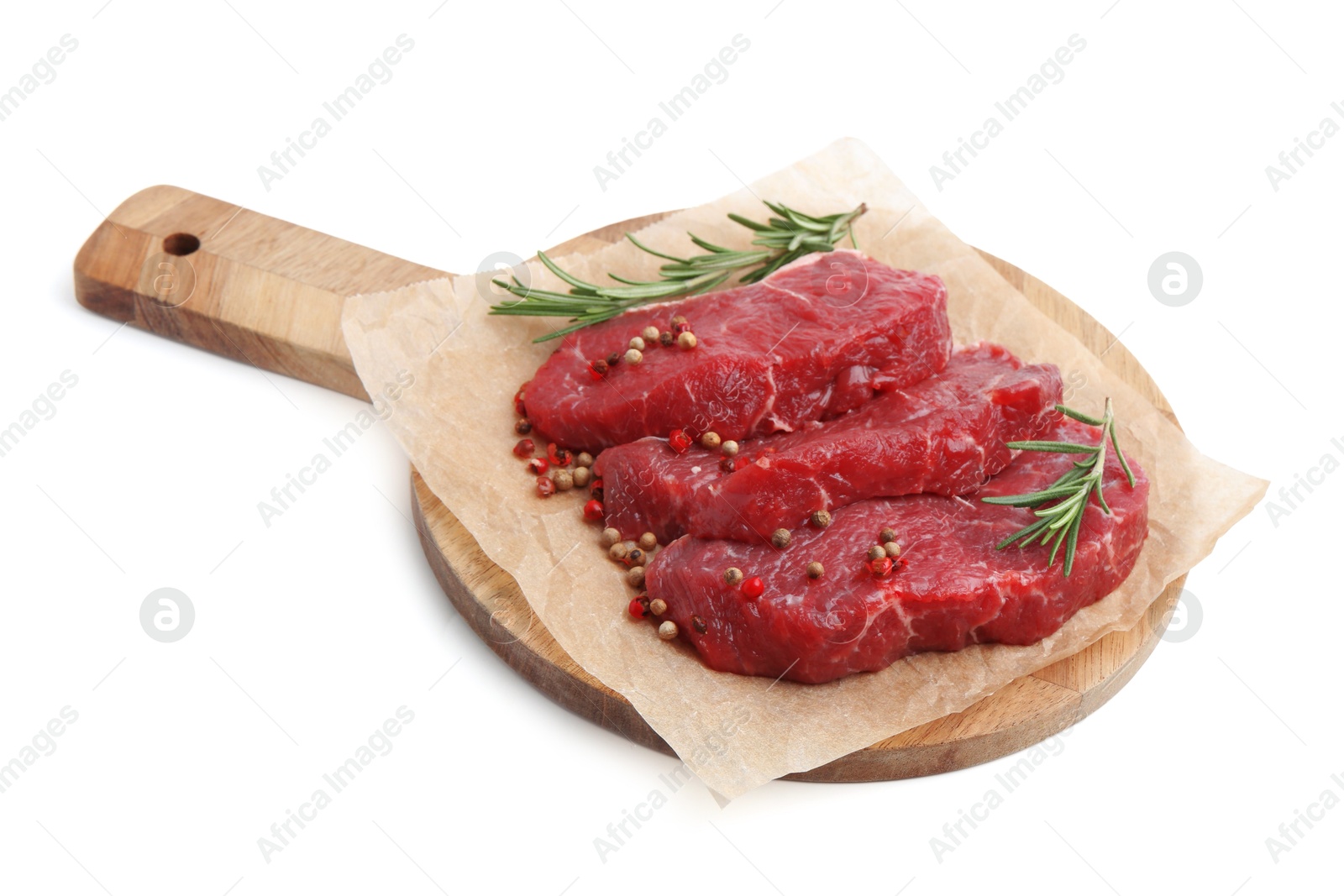 Photo of Pieces of raw beef meat, rosemary and peppercorns isolated on white