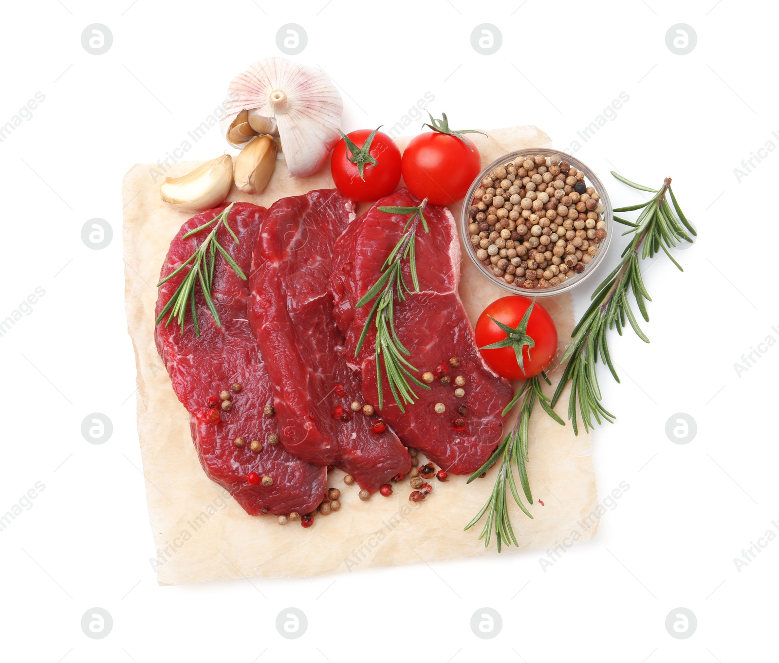 Photo of Pieces of raw beef meat, spices and tomatoes isolated on white, top view