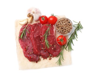 Photo of Pieces of raw beef meat, spices and tomatoes isolated on white, top view