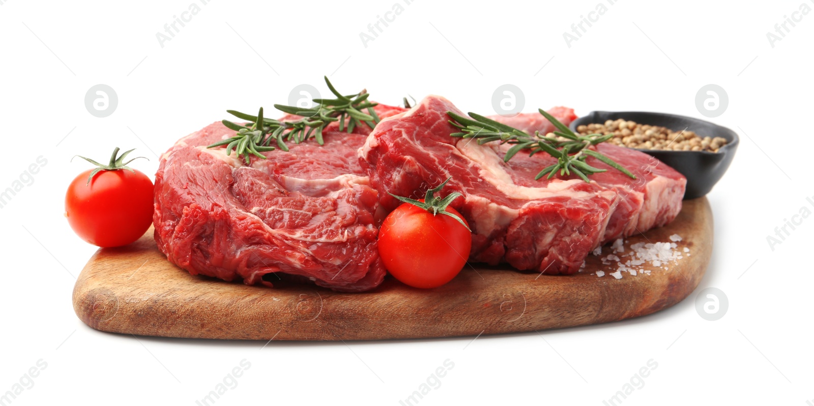 Photo of Pieces of raw beef meat, spices and tomatoes isolated on white