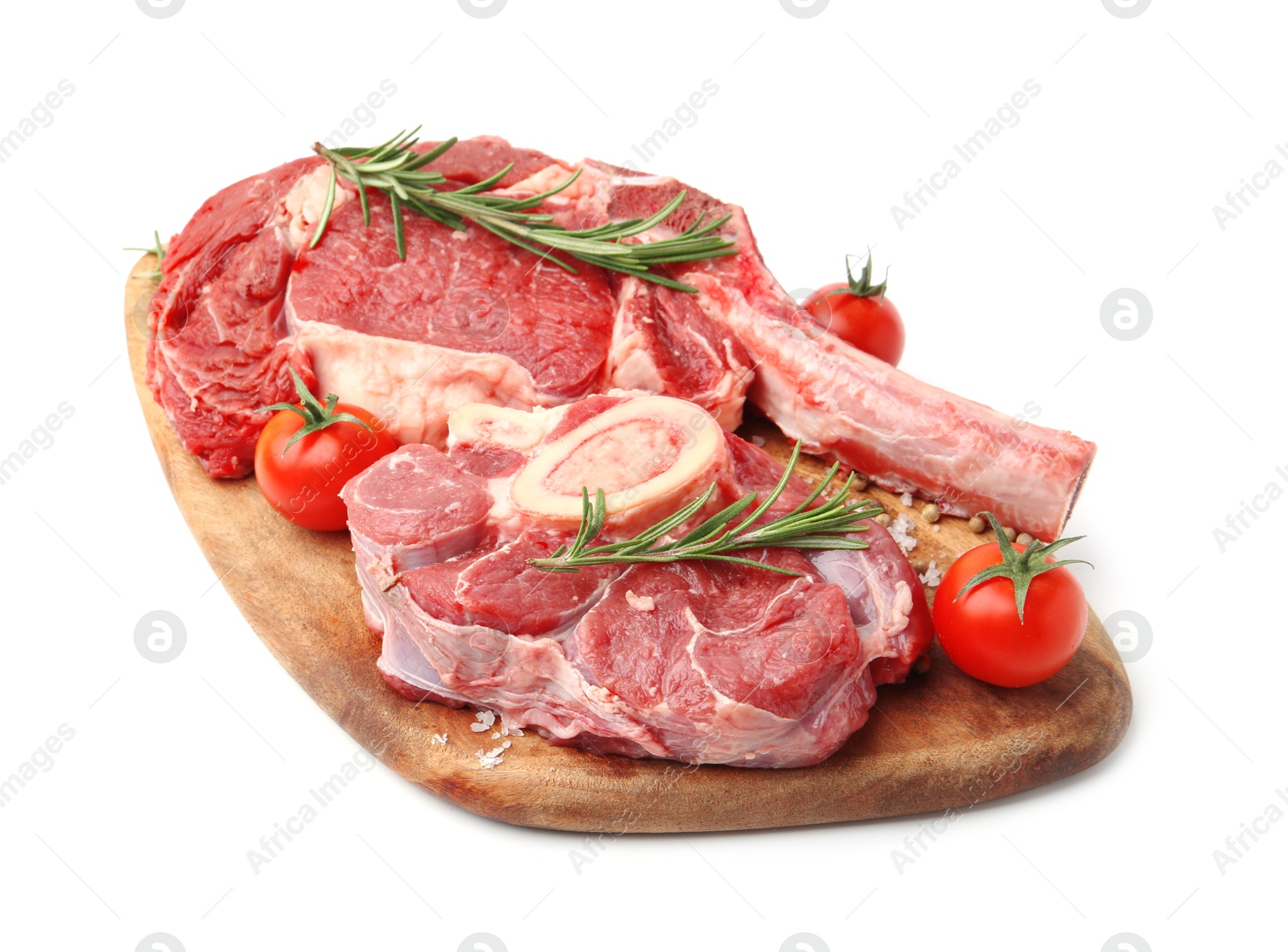 Photo of Pieces of raw beef meat, spices and tomatoes isolated on white