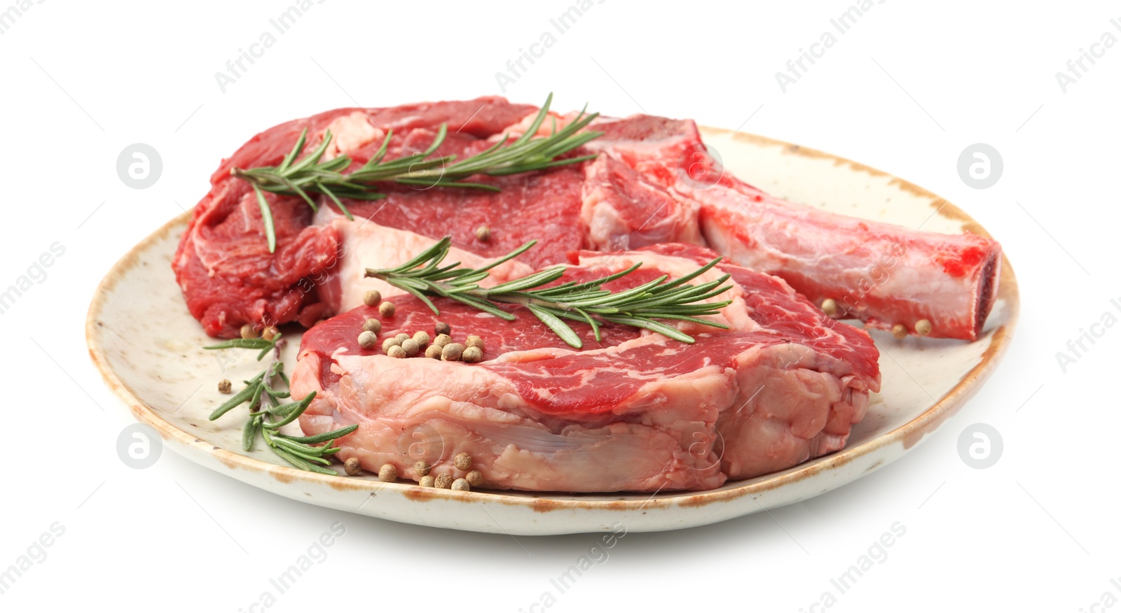 Photo of Pieces of raw beef meat and spices isolated on white