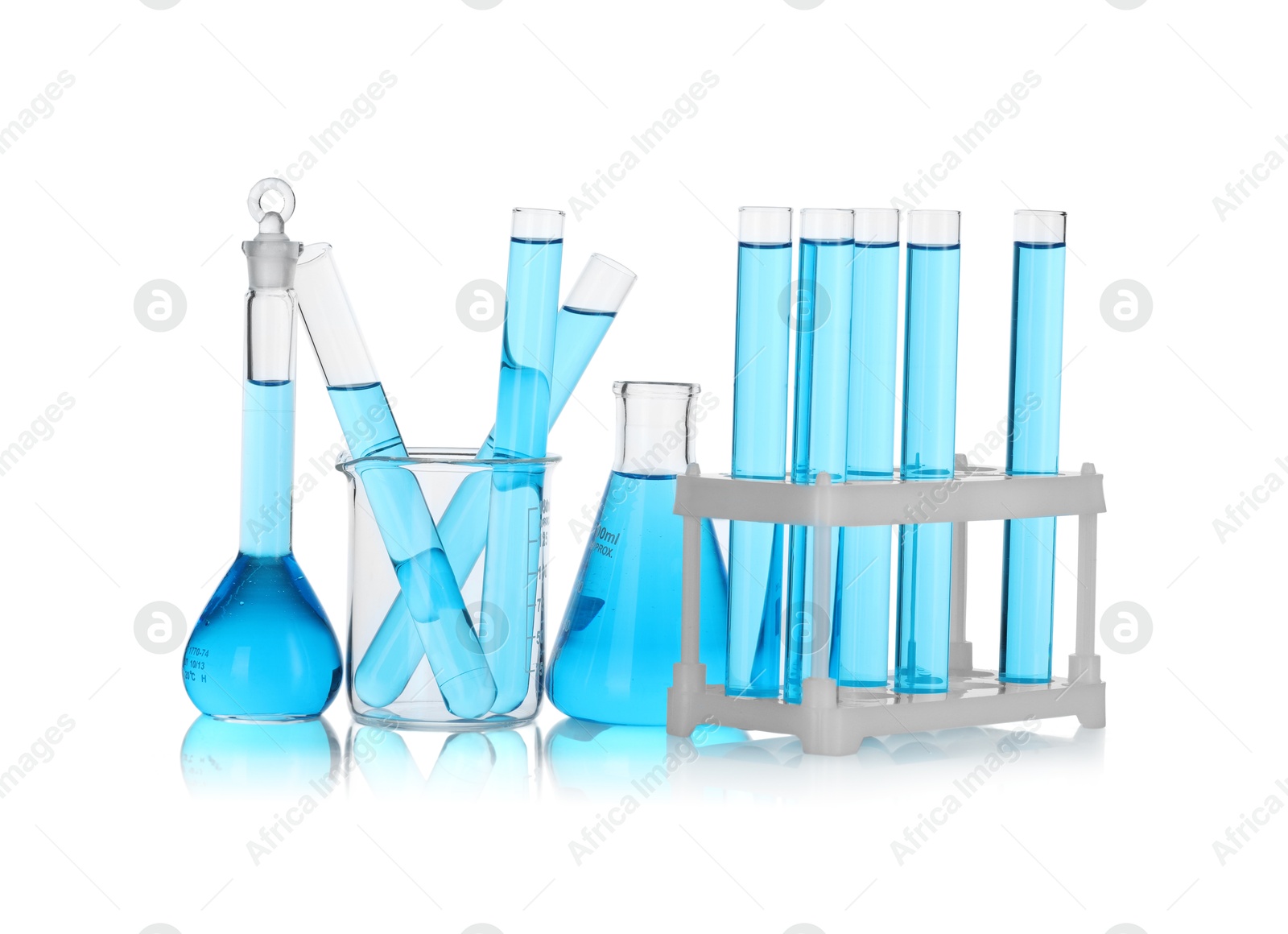 Photo of Laboratory glassware with blue liquid isolated on white