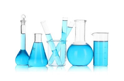 Photo of Laboratory glassware with blue liquid isolated on white