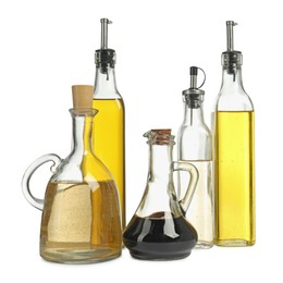 Photo of Oil and vinegar in bottles isolated on white