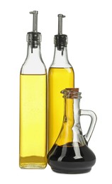 Photo of Oil and balsamic vinegar in bottles isolated on white