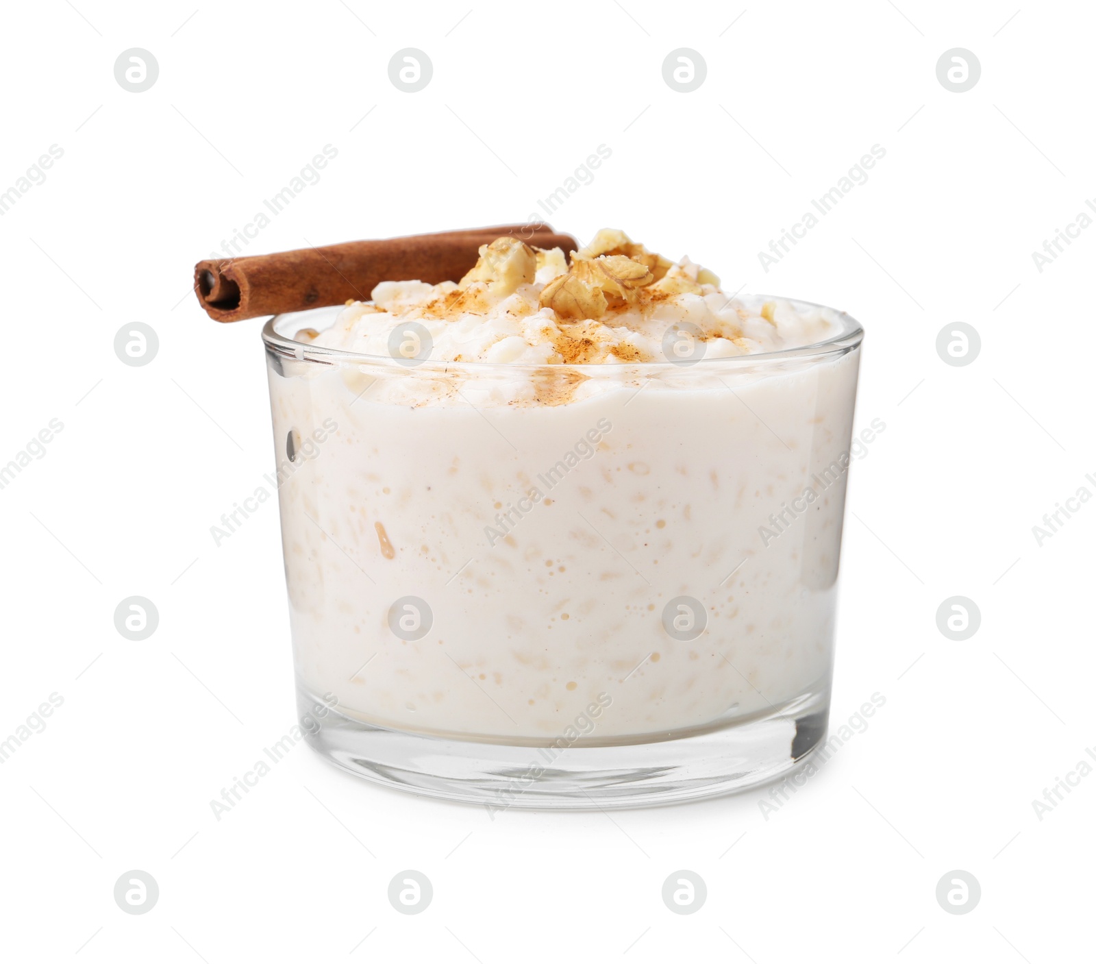 Photo of Tasty rice pudding with cinnamon and nuts in glass bowl isolated on white