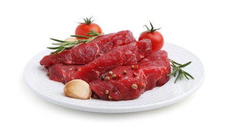 Photo of Pieces of raw beef meat, spices and tomatoes isolated on white