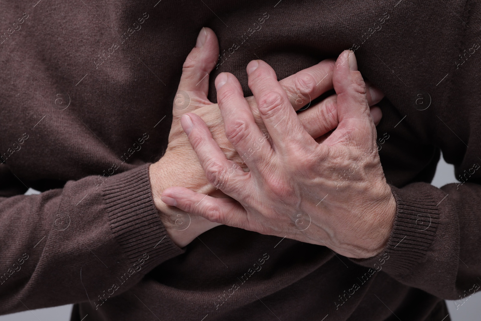 Photo of Heart attack. Senior man suffering from pain in chest, closeup