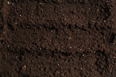 Photo of Texture of fresh soil as background, closeup