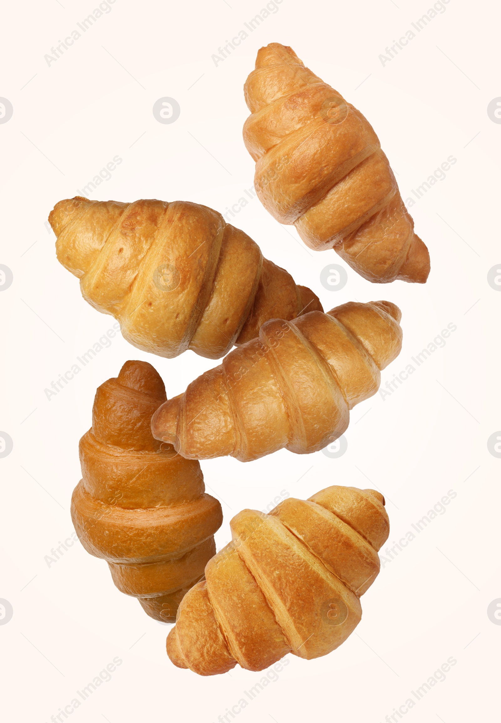 Image of Delicious croissants in air on white background. Puff pastry