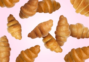 Image of Delicious croissants in air on pink background. Puff pastry