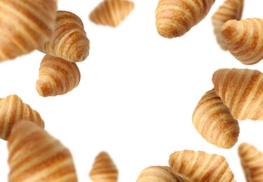 Image of Delicious croissants in air on white background. Puff pastry