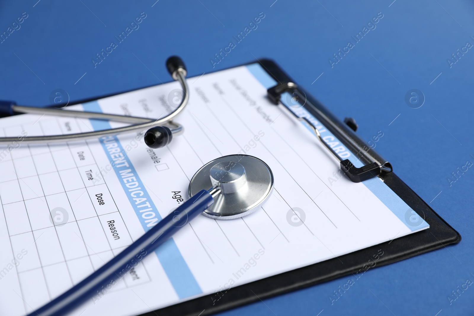 Stethoscope and medical card form on blue background, closeup Photo of Stethoscope and medical card form on blue background, closeup