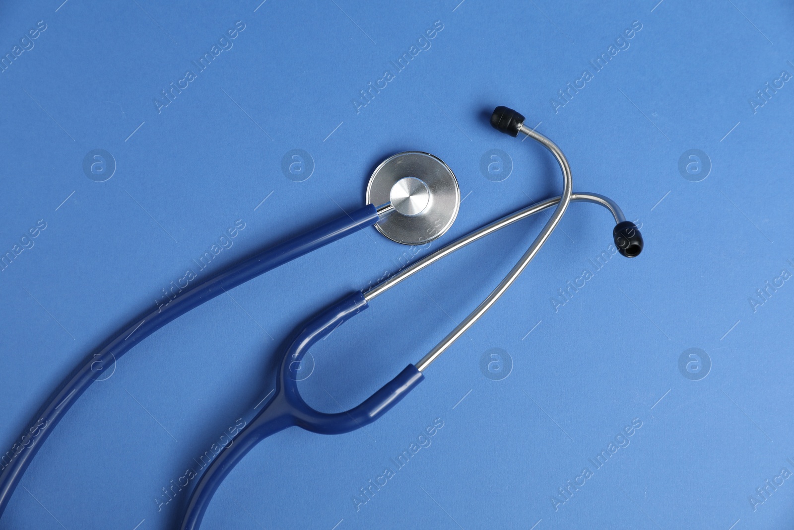 Stethoscope on blue background, top view. Medical tool Photo of Stethoscope on blue background, top view. Medical tool