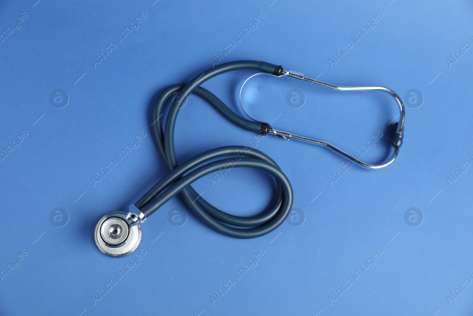 Stethoscope on blue background, top view. Medical tool Photo of Stethoscope on blue background, top view. Medical tool