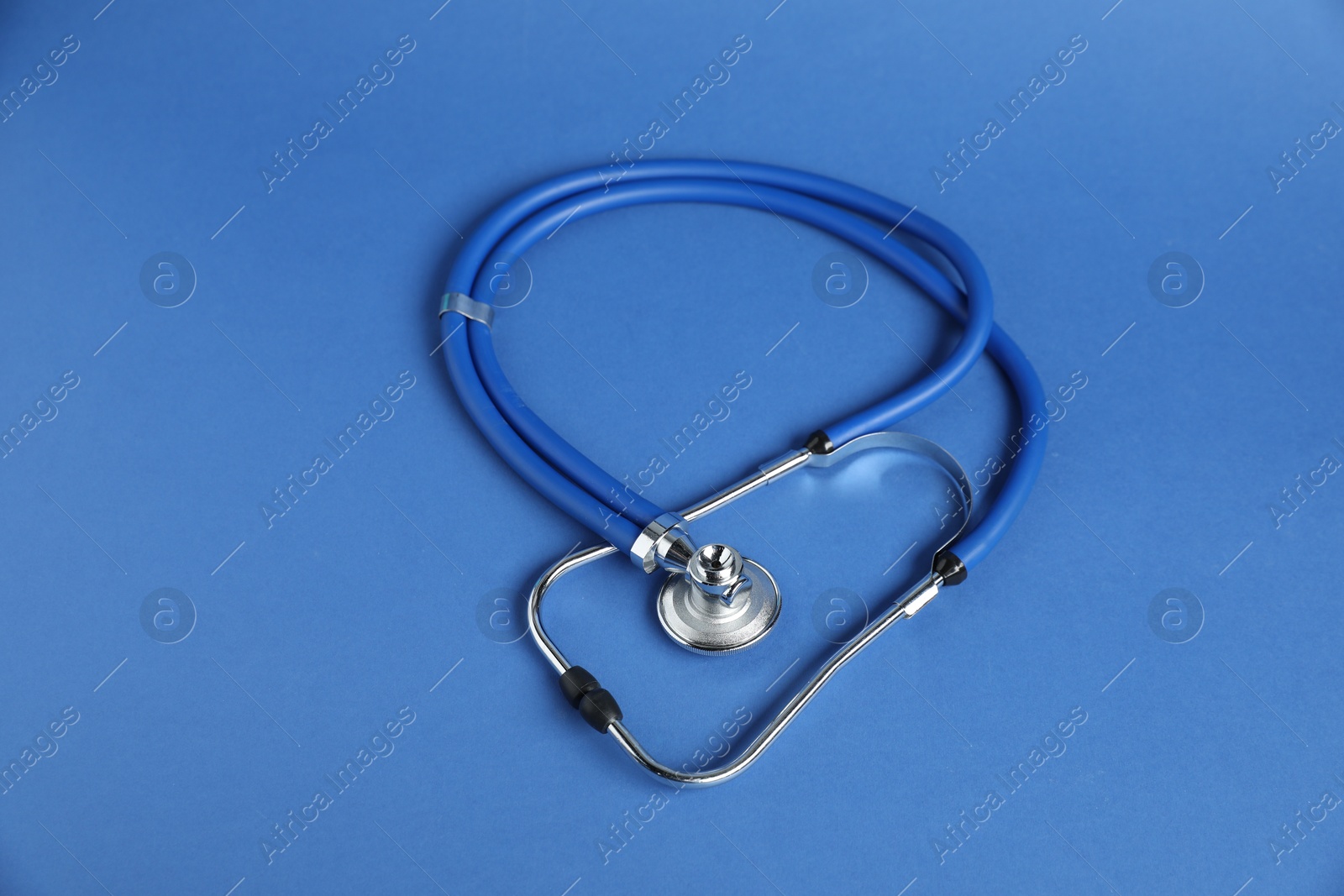 Stethoscope on blue background, above view. Medical tool Photo of Stethoscope on blue background, above view. Medical tool