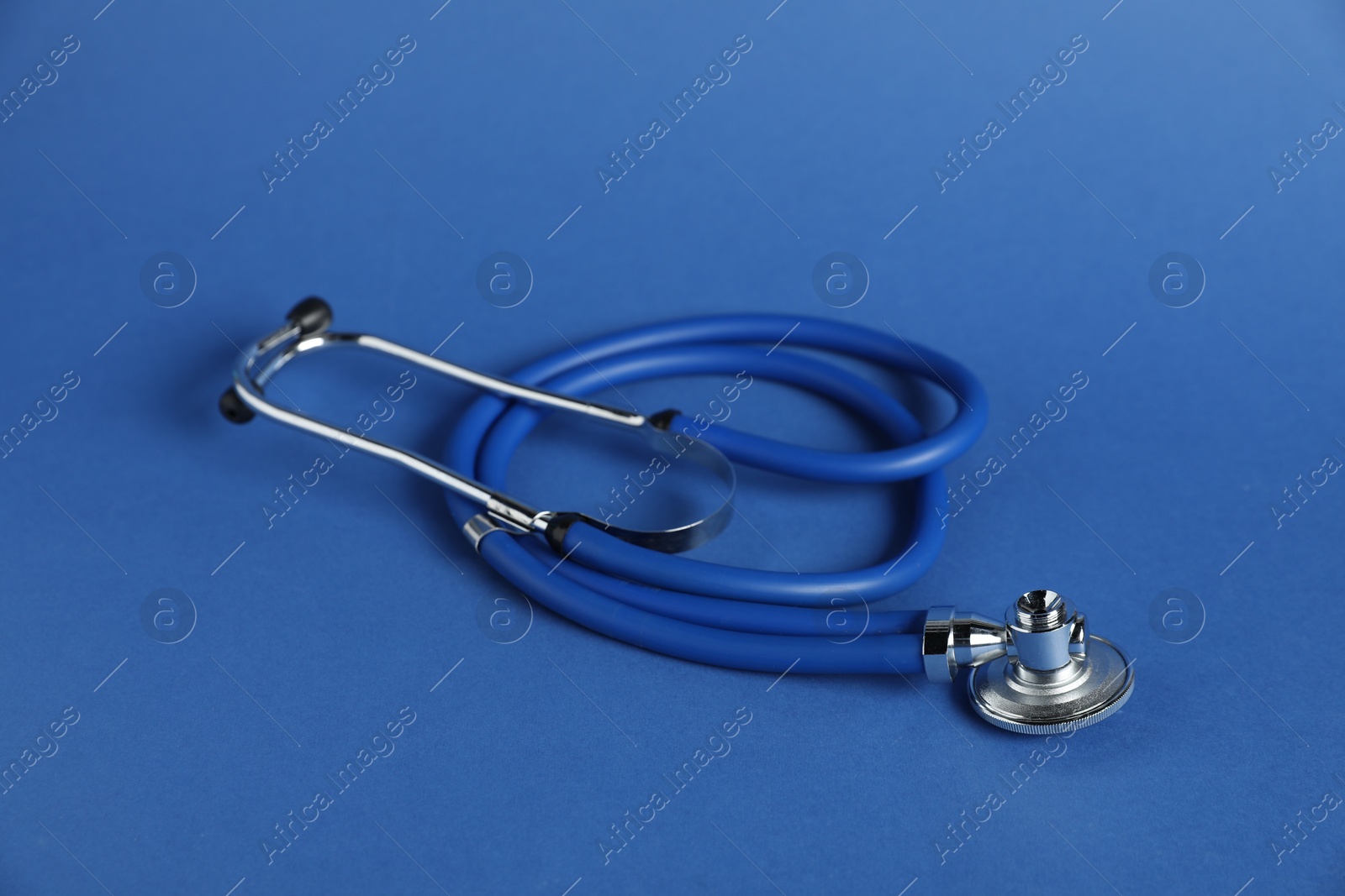 One stethoscope on blue background. Medical tool Photo of One stethoscope on blue background. Medical tool