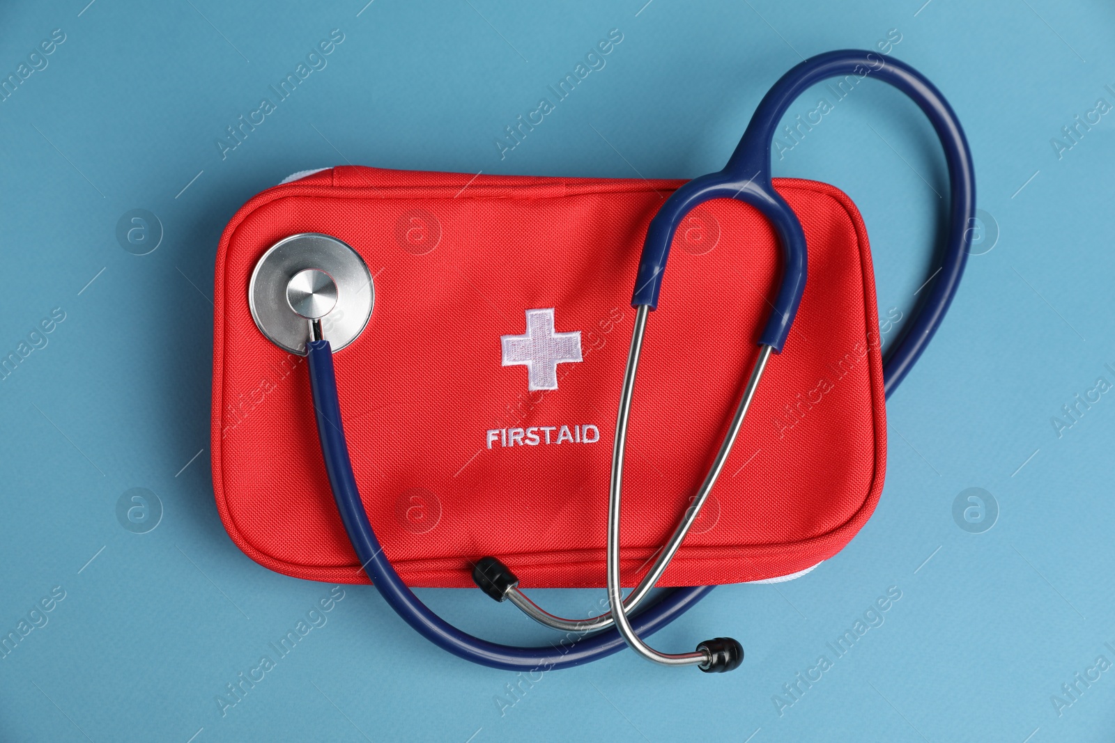 Stethoscope and first aid kit on blue background, top view Photo of Stethoscope and first aid kit on blue background, top view