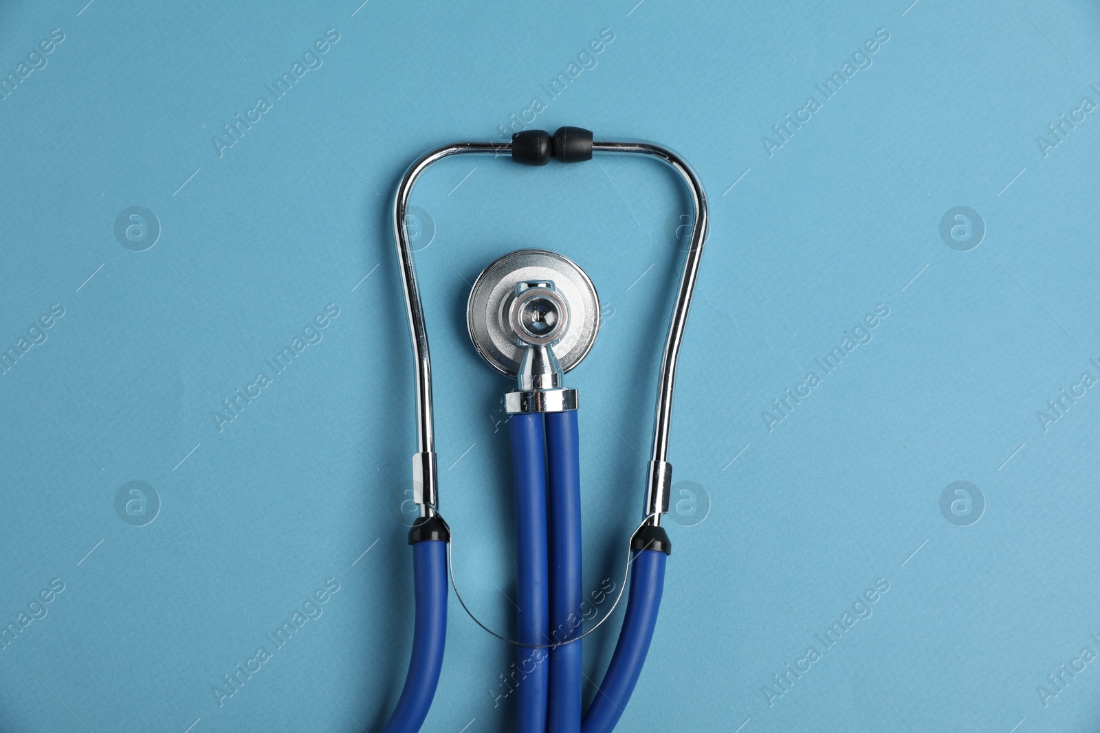 Stethoscope on light blue background, top view Photo of Stethoscope on light blue background, top view