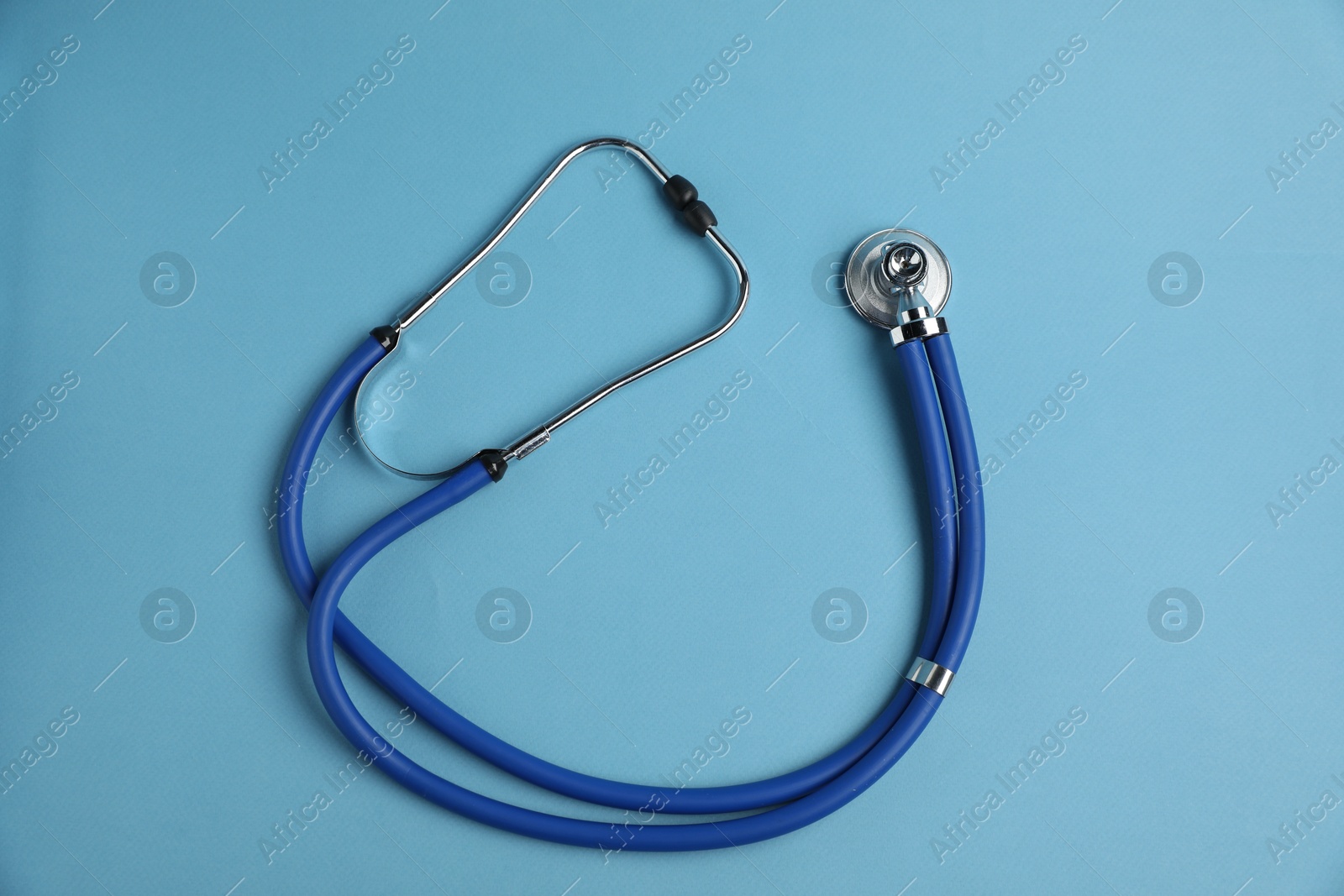 Stethoscope on light blue background, top view Photo of Stethoscope on light blue background, top view
