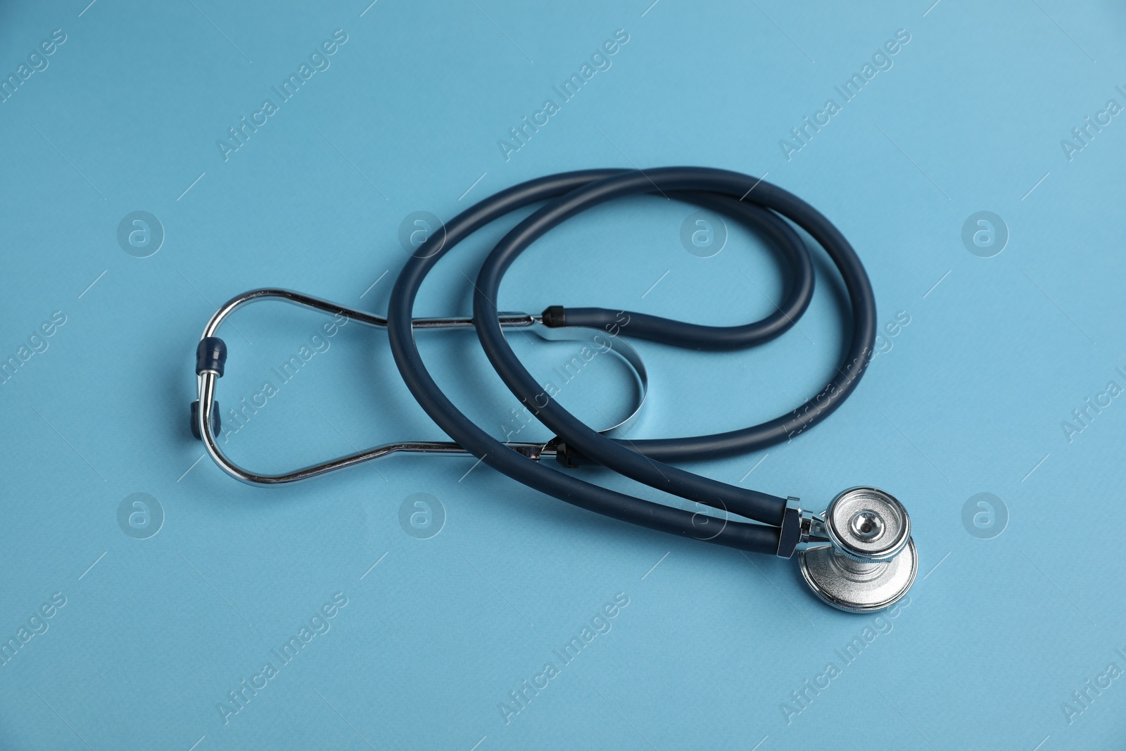Stethoscope on light blue background, above view. Medical tool Photo of Stethoscope on light blue background, above view. Medical tool