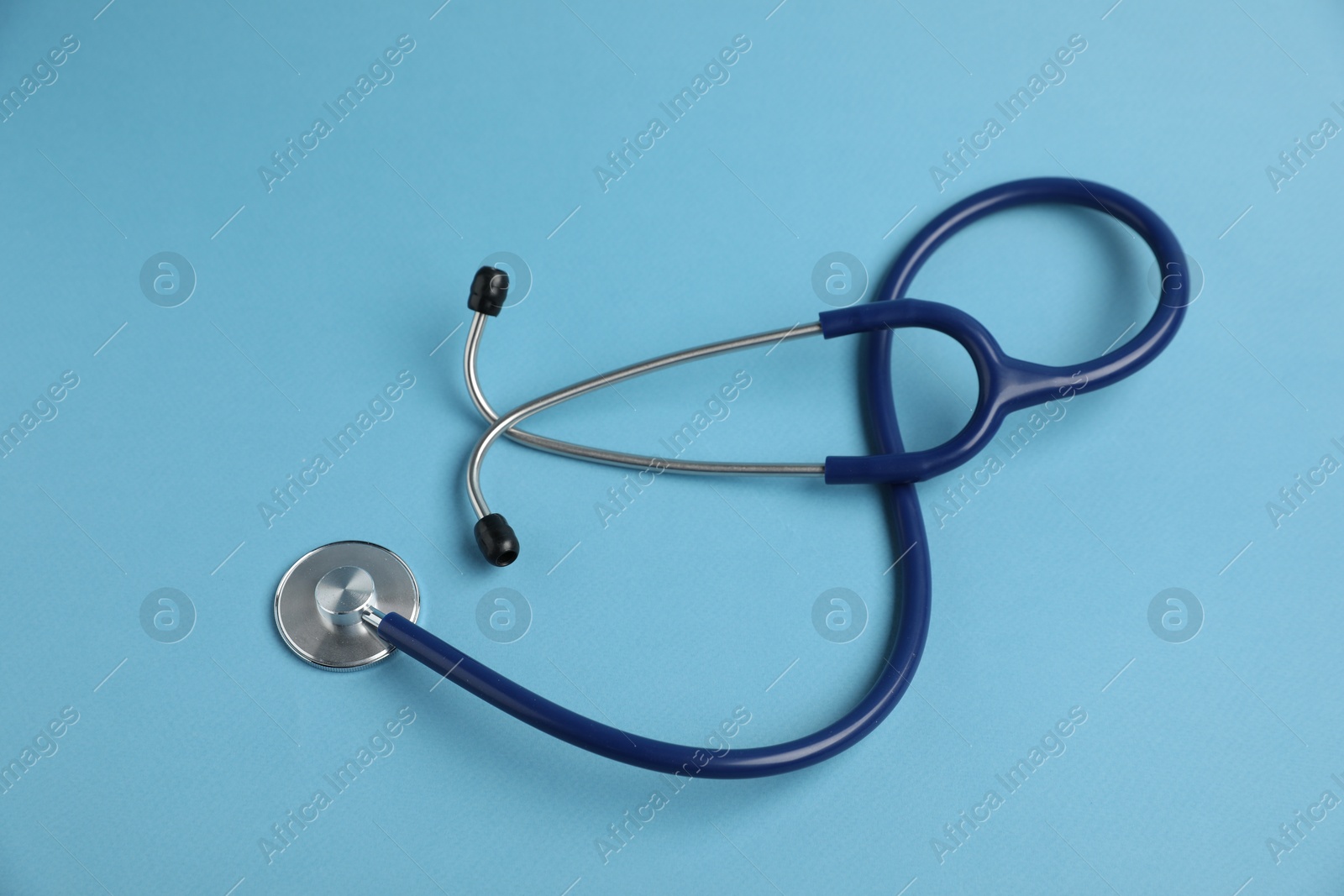 Stethoscope on light blue background, top view Photo of Stethoscope on light blue background, top view