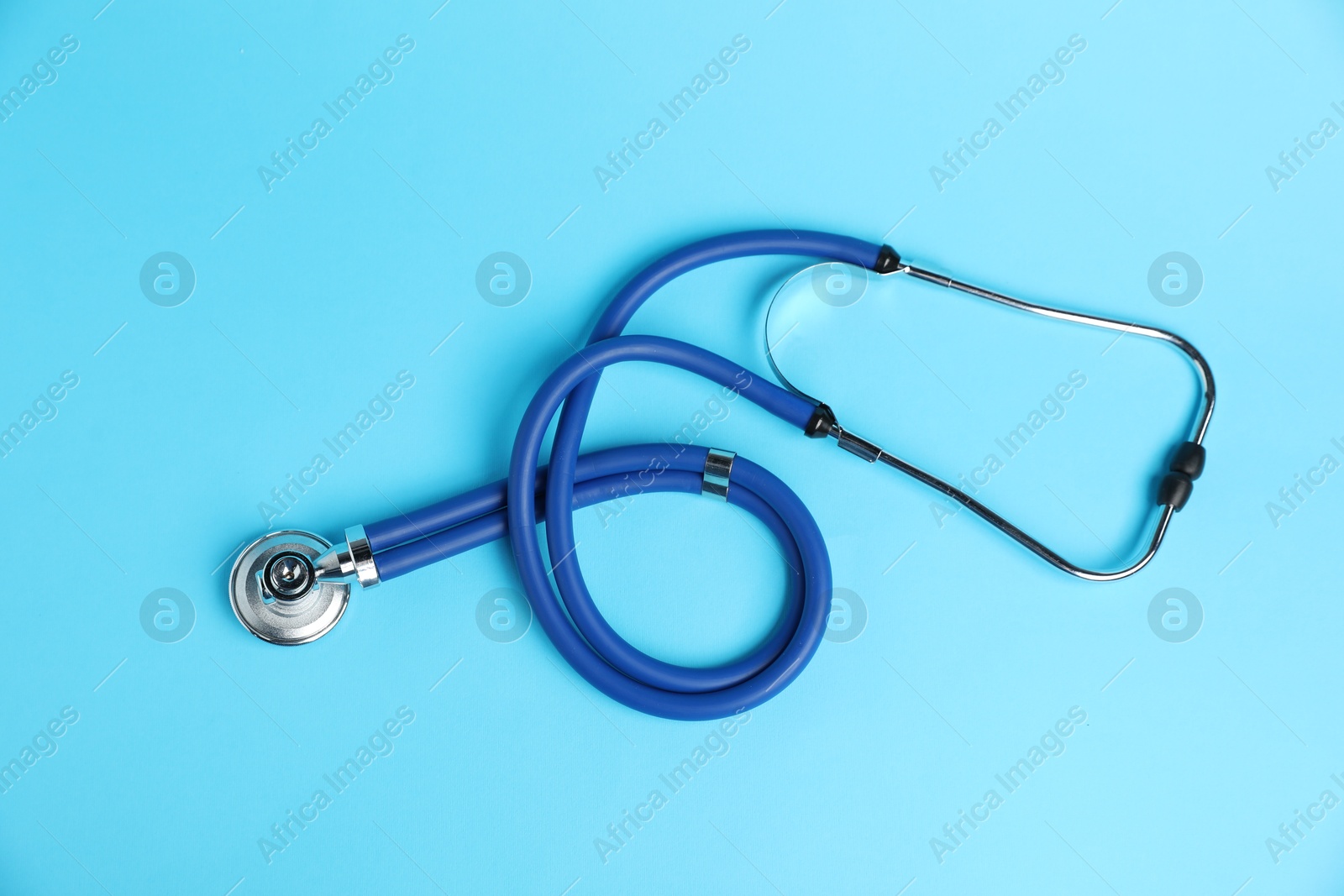 Stethoscope on light blue background, top view Photo of Stethoscope on light blue background, top view