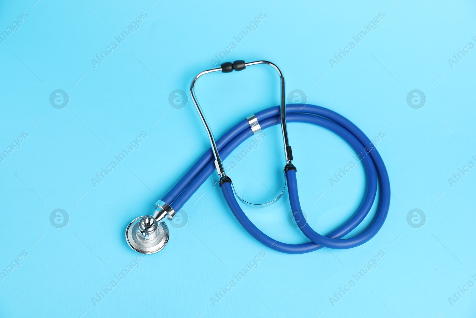 Stethoscope on light blue background, top view Photo of Stethoscope on light blue background, top view