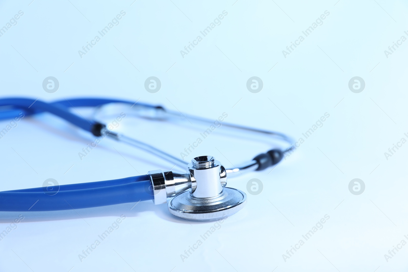 Stethoscope on light background, closeup. Medical tool Photo of Stethoscope on light background, closeup. Medical tool