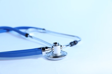 Photo of Stethoscope on light background, closeup. Medical tool