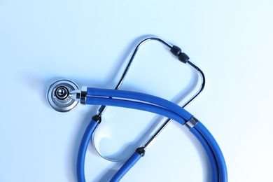 Photo of Stethoscope on light background, top view. Medical tool