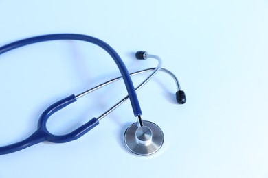 Photo of Stethoscope on light background, top view. Medical tool