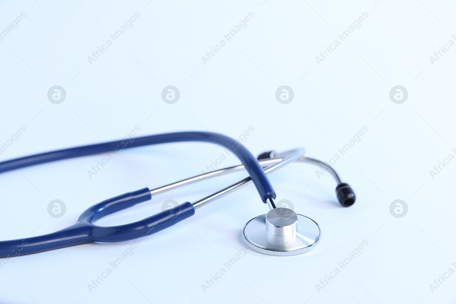 Stethoscope on light background, closeup. Medical tool Photo of Stethoscope on light background, closeup. Medical tool