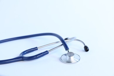 Photo of Stethoscope on light background, closeup. Medical tool