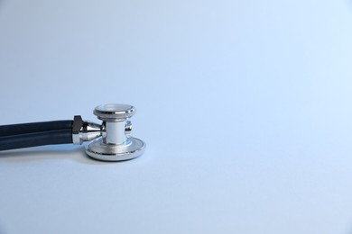 Photo of Stethoscope on light background, closeup. Medical tool