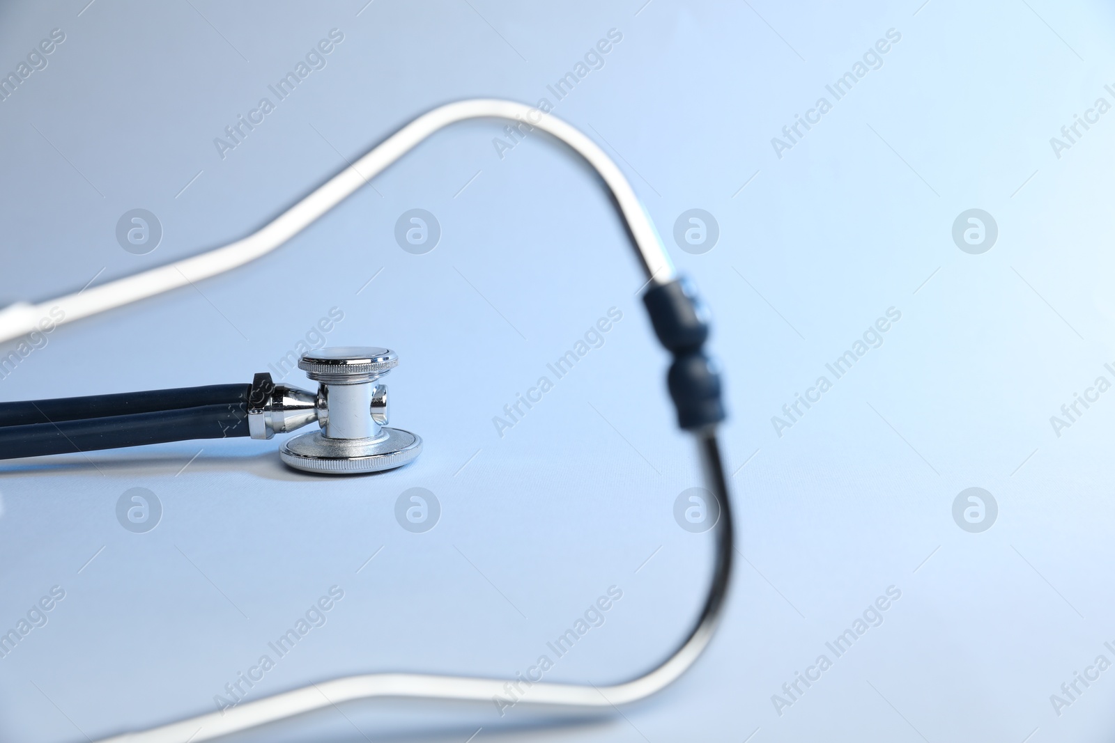 Stethoscope on light background, closeup. Medical tool Photo of Stethoscope on light background, closeup. Medical tool