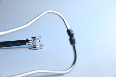 Photo of Stethoscope on light background, closeup. Medical tool